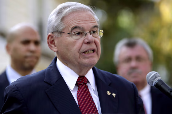 Image: U.S. Sen. Bob Menendez speaks on the yard of Peter Tom