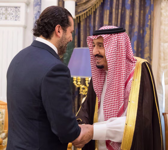 Image: Saudi King Salman, right, shakes hands with outgoing Lebanese Prime Minister Saad Hariri in Riyadh