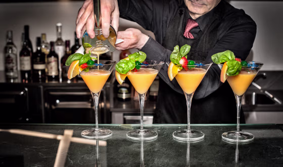Image: A bartender pours cocktails