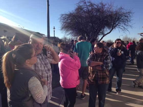 Image: Friends and family gather outside city hall following a shooting Thursday morning