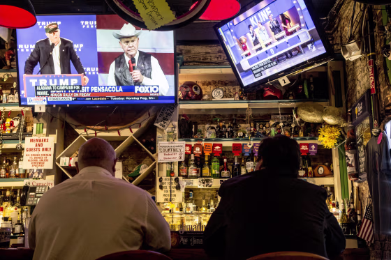 Image: A television at OK Bicycle Shop in Mobile airs a local Fox affiliate's story about the special election, announcing President Donald Trump's endorsement of Moore.