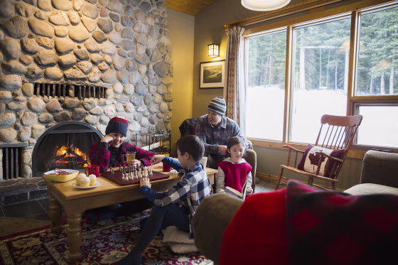 Image: Family playing chess in lodge living room