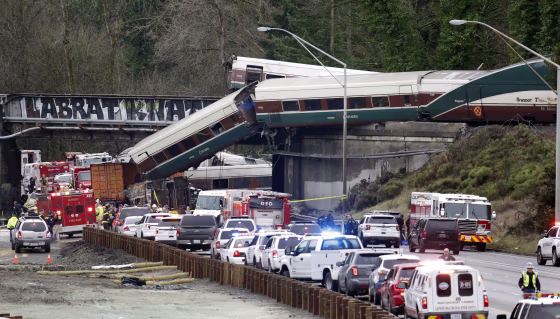 Image: Cars from an Amtrak train lay spilled onto Interstate 5