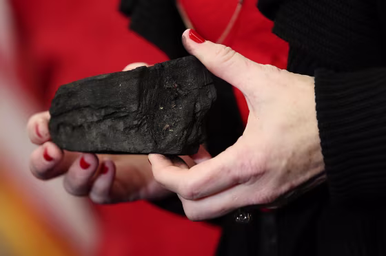 Image: Rep. Kathy Castor holds up a symbolic piece of coal