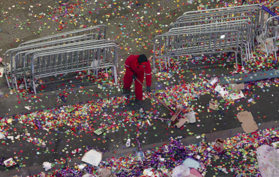 Image: A member of the cleanup crew sweeps confetti in New York's Times Square