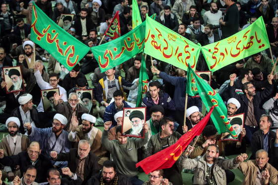Image: Iranians chant slogans as they march in support of the government near the Imam Khomeini grand mosque