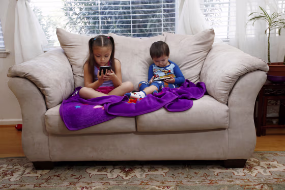Image: Juliana Sanchez, 5, and her brother, Francisco Sanchez Jr., 2, watch children's programming on YouTube on their parent's cell phones at their home on March 9, 2015 in Mountain House, California.