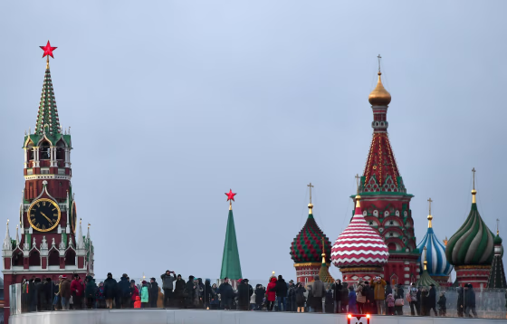 Image: The Spasskaya (Savior) Tower of the Moscow Kremlin and domes of the Intercession of the Most Holy Theotokos on the Moat Cathedral (St. Basil's Cathedral) in Moscow.