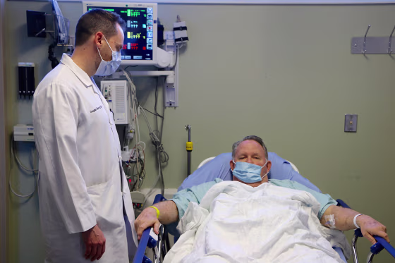 Image: Dr. Doug Olson asks patient William Ness, 70, how he is feeling after his wife drove him to the emergency room and he was diagnosed with flu at Northside Hospital Emergency Room in Cumming, Georgia, on Jan. 29, 2018.