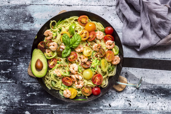 Image: Frying pan of spaghetti with zoodles, guacamole, tomatoes and shrimps