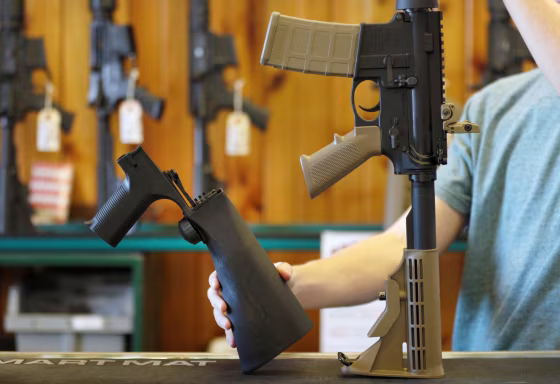 Image:  A bump fire stock, left, that attaches to a semi-automatic rifle...