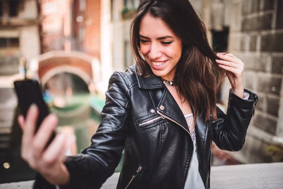 Image: tourist woman self photographing in venice