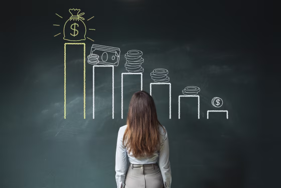 Image: Businesswoman looking at a financial chart on chalkboard