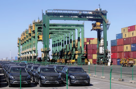 Image: Imported Mercedes Benz cars are seen next to containers at Tianjin Port