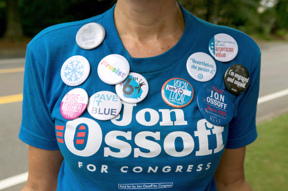 Image: Cherish Burnham of Roswell decorates her shirt with political buttons and shows her support of Democratic candidate Jon Ossoff