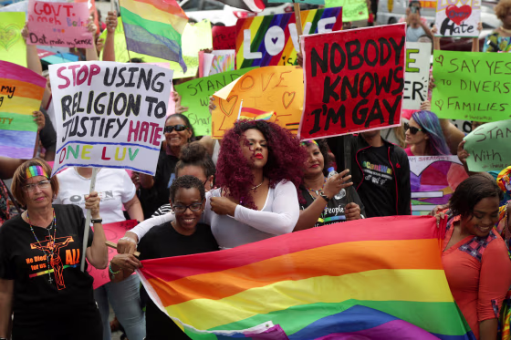 Image: Members of the LGBT community demonstrate outside the Hall of Justice in Port-of-Spain