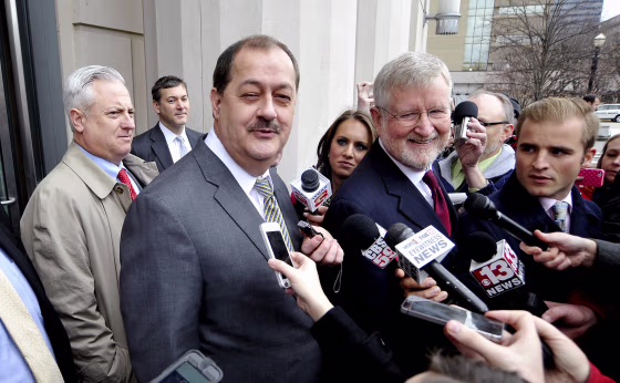 Image: Former Massey Energy Chief Executive Don Blankenship and his attorney Bill Taylor are met by media outside the Robert C. Byrd U.S. Courthouse in Charleston West Virginia