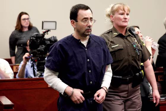 Image: Larry Nassar, a former team USA Gymnastics doctor, who pleaded guilty in November 2017 to sexual assault charges, is led from the courtroom after listening to victim testimony during his sentencing hearing in Lansing, Michigan