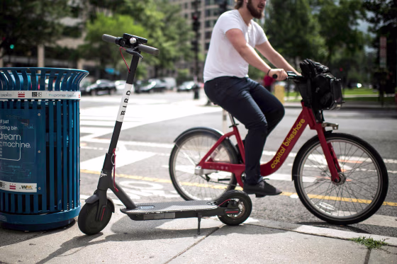 Image: A Bird electric scooter is parked on a street in downtown Washington