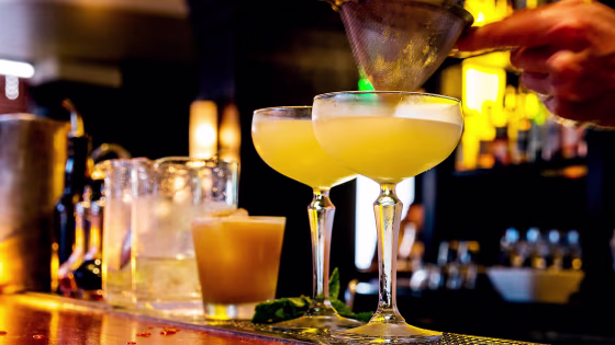 Image: Cocktail being poured at a bar.