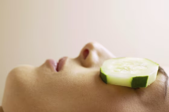 Image: Woman with cucumber slices covering eyes