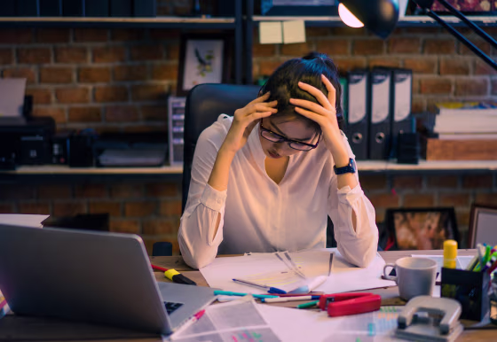 Image: A woman sits at her desk