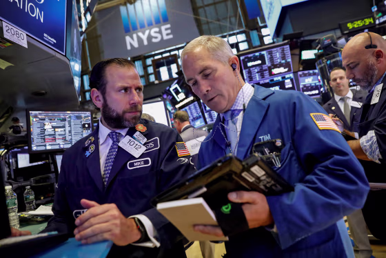 Image: Traders work on the floor of the NYSE in New York