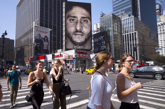 Image: People walk by a Nike advertisement featuring Colin Kaepernick on display on Sept. 6, 2018, in New York