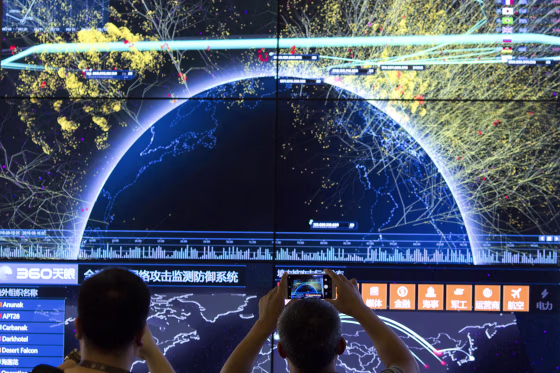 An attendee takes a photo of a visualization of global internet attacks during the 4th China Internet Security Conference in Beijing on Aug. 16, 2016.