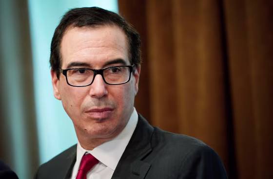 Image: Treasury Secretary Steven Mnuchin watches as President Donald Trump speaks during a meeting with Republican members of Congress and Cabinet member