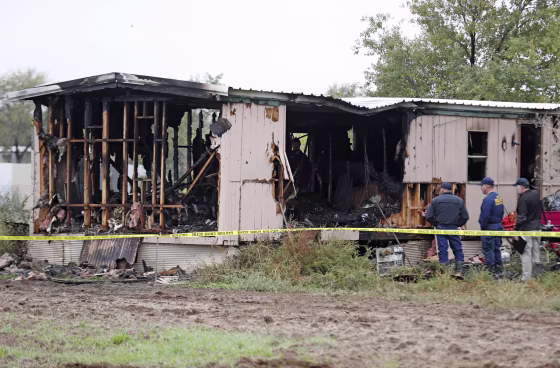 Fire marshals investigate the cause of a deadly house fire near Wolfforth, Texas, on Nov. 8, 2018.