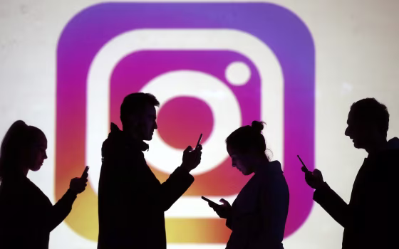 Silhouettes next to an Instagram logo.