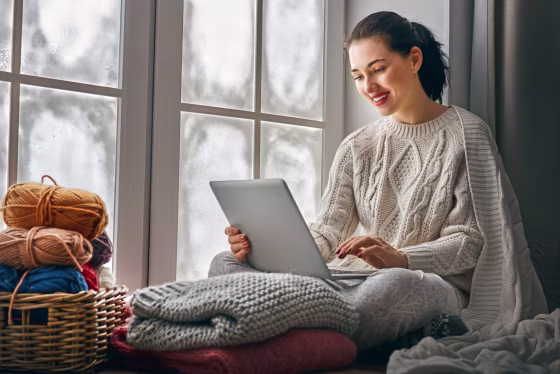 Image: woman sitting near windows