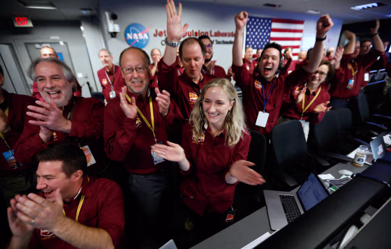 NASA flight team engineers celebrate the InSight spacecraft's successful landing on Mars at the NASA Jet Propulsion Laboratory in Pasadena, California, on Nov. 26, 2018.