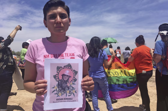 Gabriela Hernandez, executive director of the nonprofit New Mexico Dream Team, holds up an image of Roxsana Hernandez outside an ICE office in Albuquerque on June 6, 2018.
