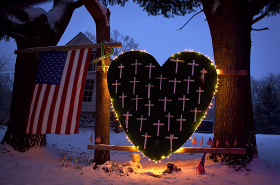 Image: A heart bearing 26 crosses, one for each victim of the Sandy Hook massacre