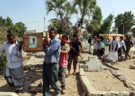 Image: Mourners walk through a cemetery carrying the coffin of one of the victims of reported bombardment in the rebel-held Hodeida, Yemen, on Dec. 10, 2018.