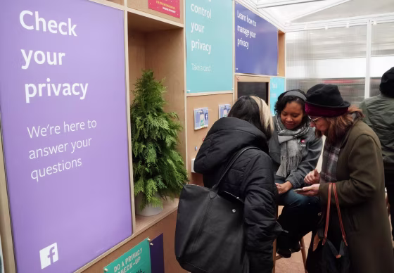 Facebook employees talk to visitors at "Privacy Pop-Up" kiosk in Bryant Park in New York on Dec. 13, 2018.
