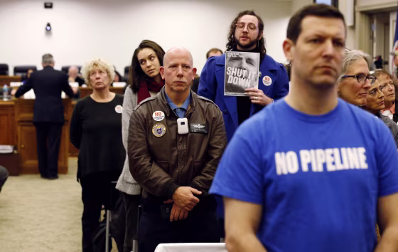 Image: Pipeline opponents turn their backs on an air pollution panel as they delay a key vote on the Atlantic Coast Pipeline in Richmond, Virginia, on Dec. 19, 2018.