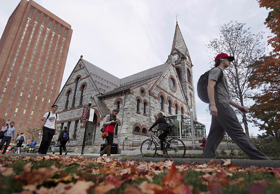 Image: Students pass the Old Chapel at the University of Massachusetts campus in Amherst on Oct. 21, 2016.
