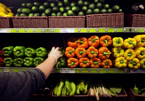 Image: An employee stocks the shelves with fresh peppers in the produce section of a Whole Foods Market store in Dublin, Ohio, on Nov. 7, 2014.
