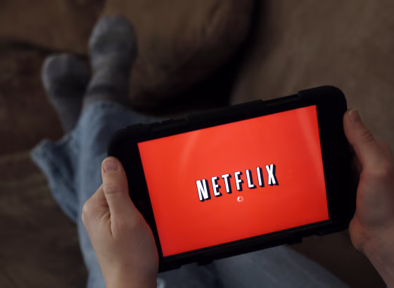 Image: A person displays Netflix on a tablet