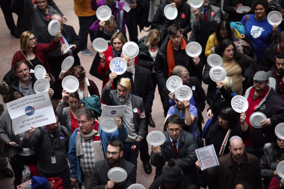 Furloughed federal workers and those aligned with them protest the partial government shutdown in the Hart Senate Office Building