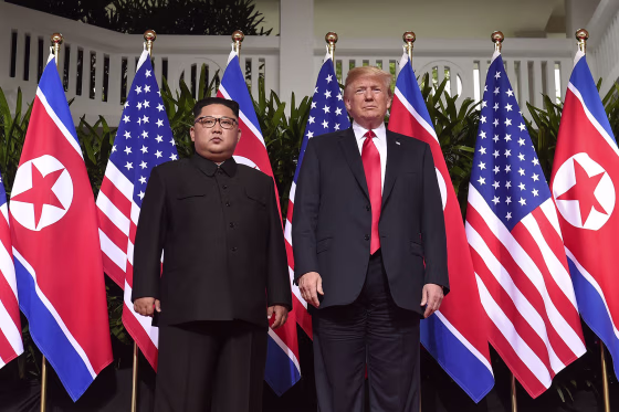 Image: President Donald Trump poses with North Korea's leader Kim Jong Un at the start of their historic US-North Korea summit