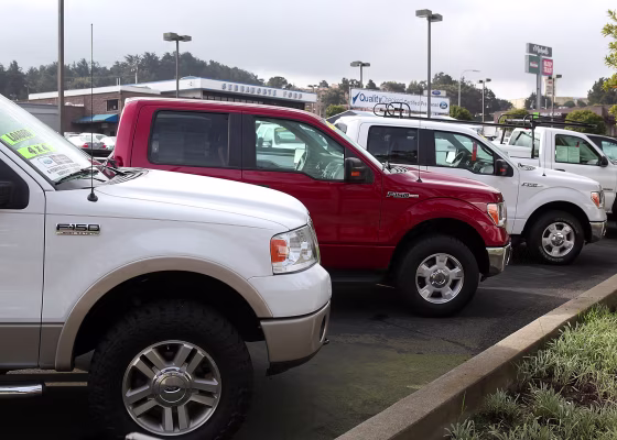 Image: Ford F-150 pickup trucks sit on the sales lot at Serramonte Ford