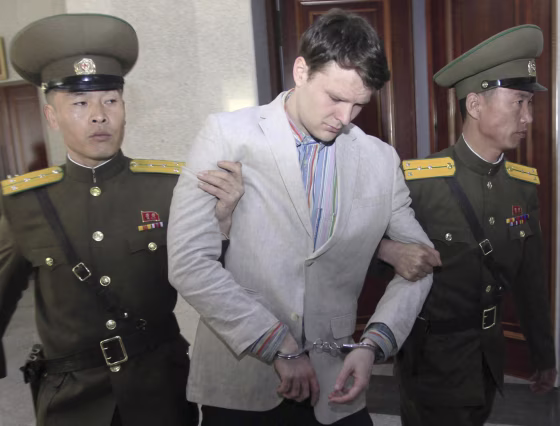 Image: Otto Warmbier is escorted at the Supreme Court in Pyongyang
