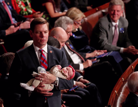 Image: U.S. Rep. Eric Swalwell (D-CA) holds his daughter Kathryn as the U.S. House of Representatives meets for the start of the 116th Congress in Washington