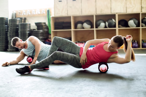 People in gym using support roller