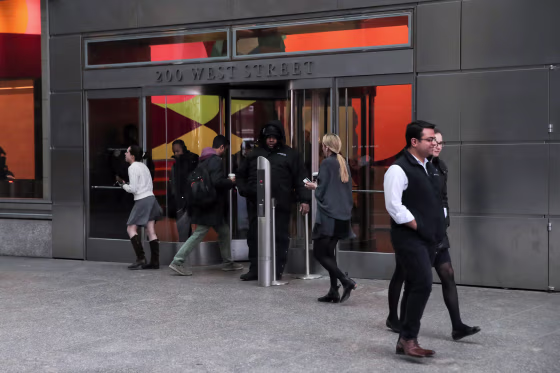 Image: People enter and exit 200 West Street the Goldman Sachs building in New York on March 6, 2019.