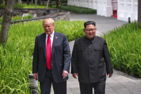 Image: U.S. President Donald Trump walks with North Korean leader Kim Jong Un at the Capella Hotel on Sentosa island in Singapore